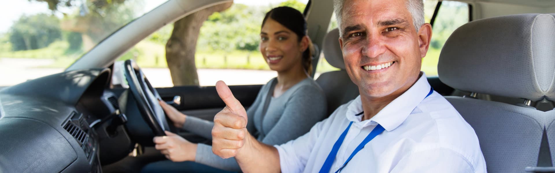 Drivers instructor smiling at his student